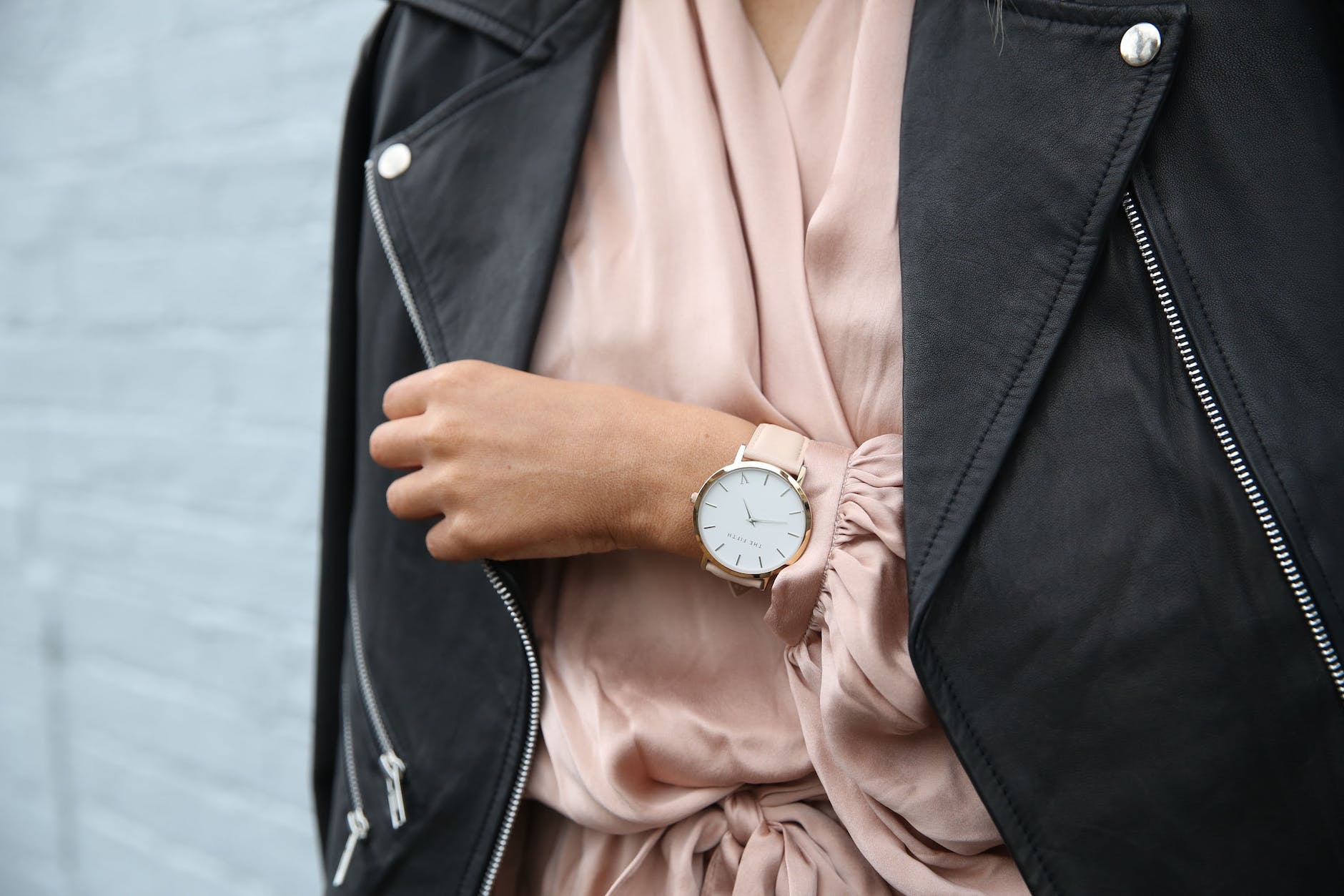 woman wearing peach dress and black jacket s left hand closeup photography