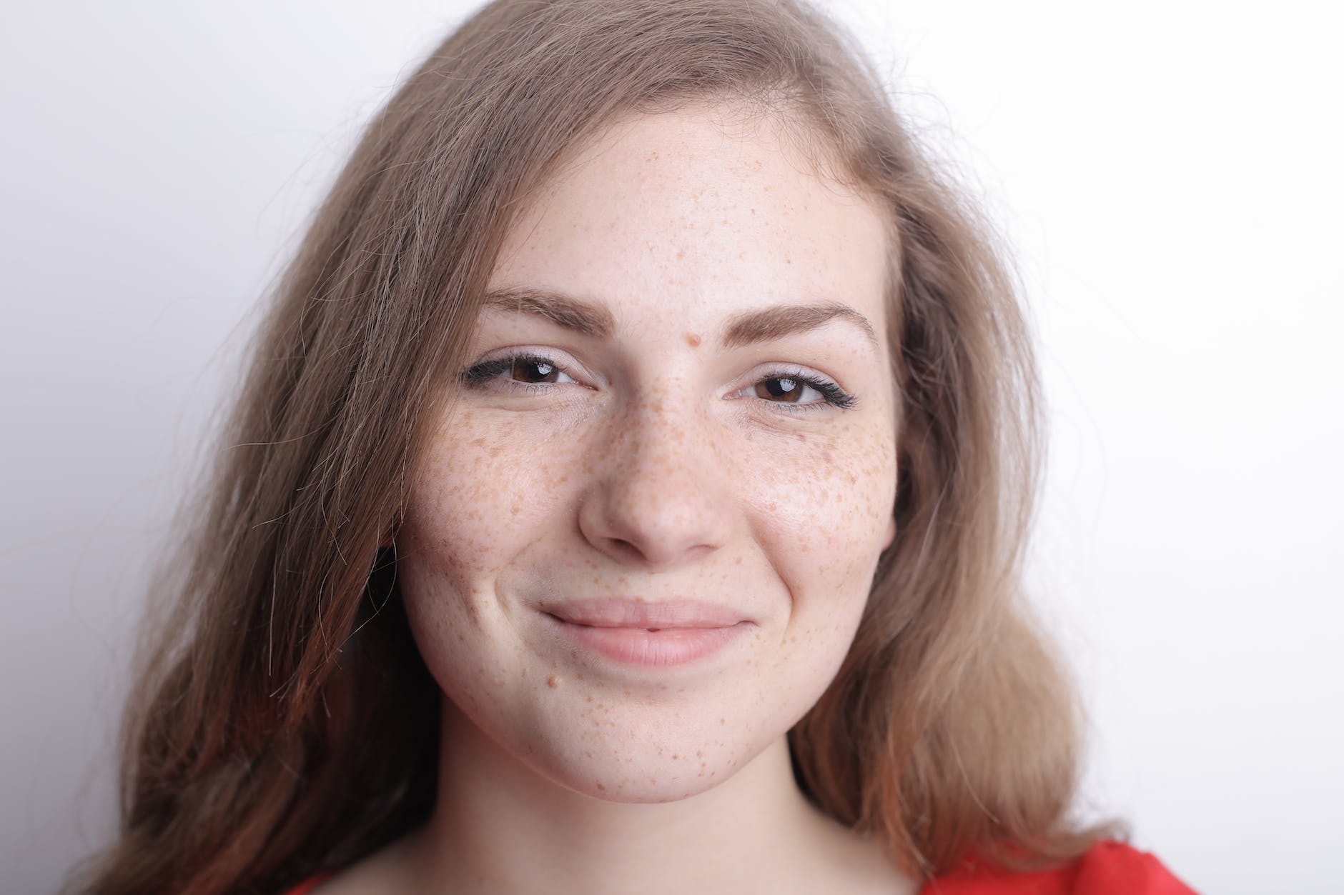 young woman with freckles on face